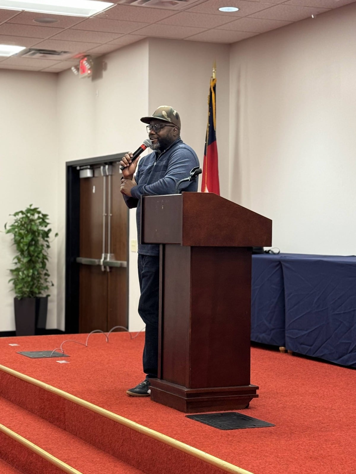 Darius Evans speaking at a lectern